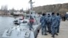 Ukrainian servicemen gather near the vessel Nikopol, one of three Ukraine's naval ships captured in the Kerch Strait and then returned by Russia, in the port of Ochakiv, Nov. 20, 2019.