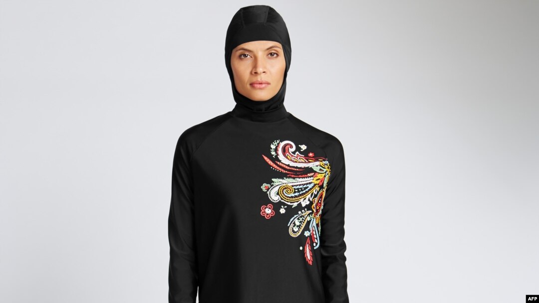 In a recent undated handout picture released by British retailer Marks and Spencer, April 8, 2016, a model poses wearing one of Marks and Spencer's full-body bathing suit or burkini suit.