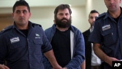 FILE - Israeli Yosef Haim Ben David (C), convicted in the killing of 16-year-old Palestinian Abu Khdeir, arrives at a court in Jerusalem, April 19, 2016. Ben David was sentenced Tuesday to life plus 20 years in prison.