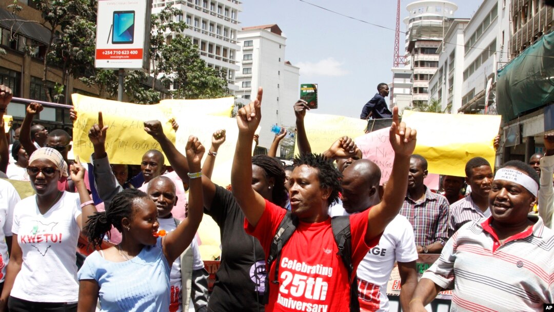 Kenya civil rights groups protest on the streets of Nairobi holding placards against the government closure of the three main TV stations in Nairobi, Feb. 5, 2018. 