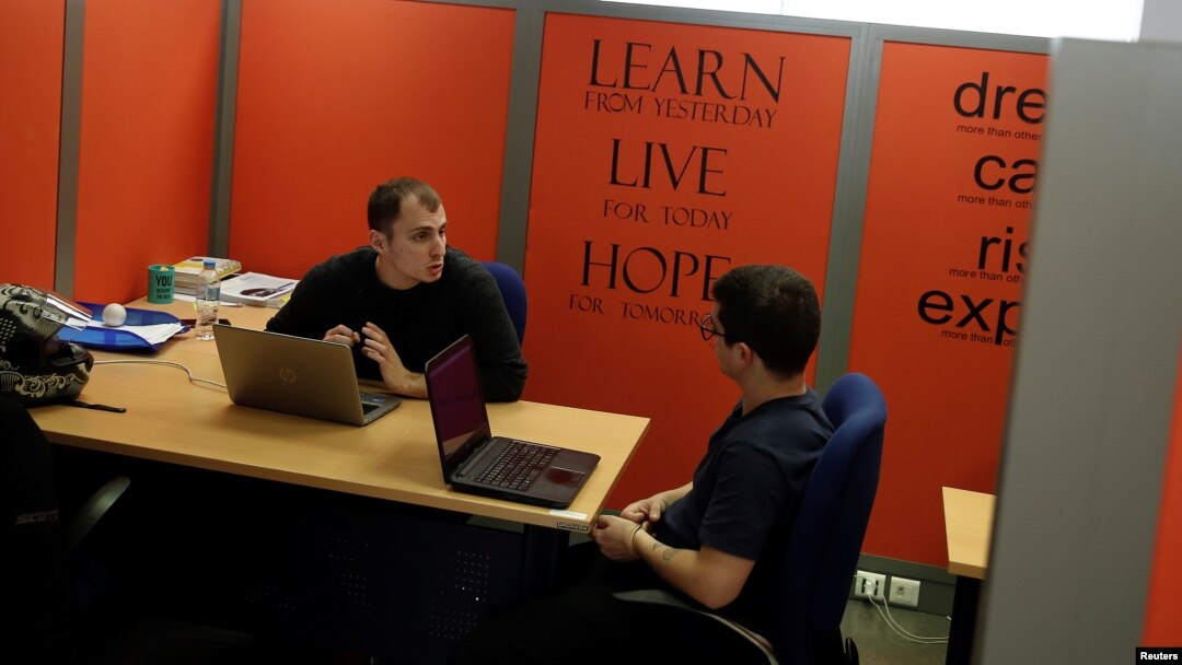 Young entrepreneurs discuss in their office, in a building offered by Eurobank's startup accelerator program EGG in Athens, Greece, February 22, 2018.