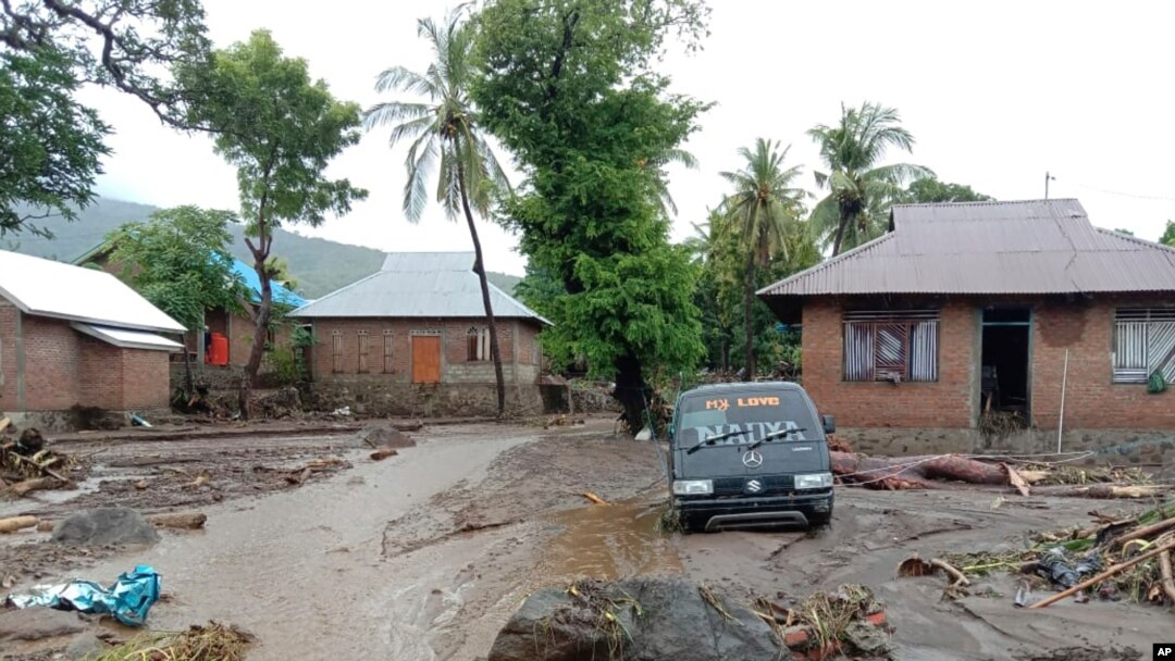 A damaged vehicle sits in the flood water in Ile Ape, on Lembata Island, East Nusa Tenggara province, Indonesia, April 4, 2021.