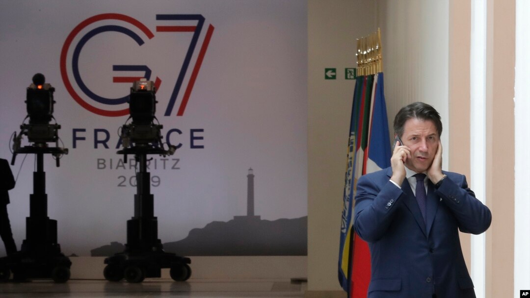 Italian Premier Giuseppe Conte speaks on the phone on the second day of the G-7 summit in Biarritz, France, Aug. 25, 2019. 