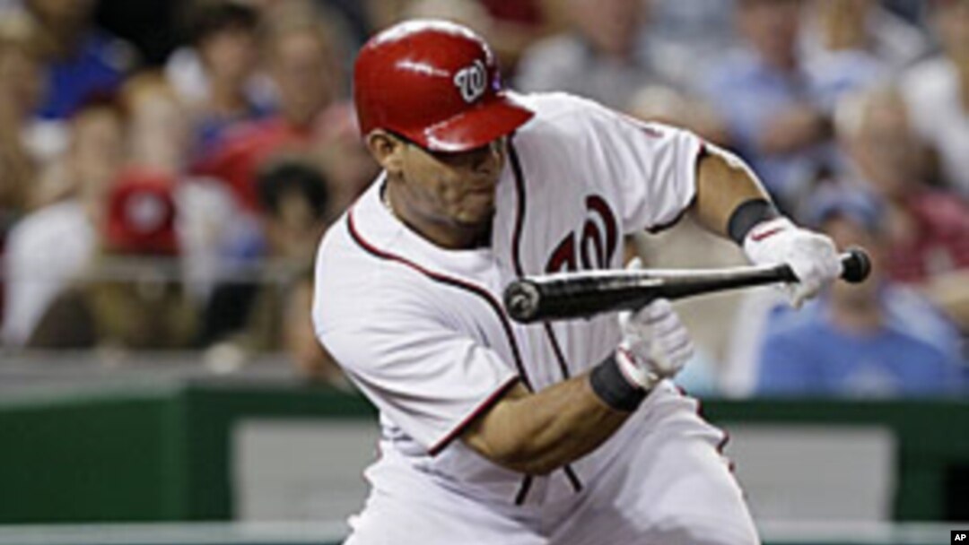 Washington Nationals' Wilson Ramos hitting a sacrifice bunt to drive in teammate Michael Morse for the go-ahead run in the seventh inning against the Chicago Cubs at Nationals Park in Washington, July 6, 2011.