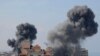 TOPSHOT - Smoke billows from residential buildings following Israeli airstrikes in Gaza City on October 7, 2023.
