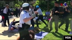 FILE - Police in Washington try to break up a clash between protesters and supporters of Turkish President Recep Tayyip Erdogan near the Turkish ambassador's residence, May 16, 2017.