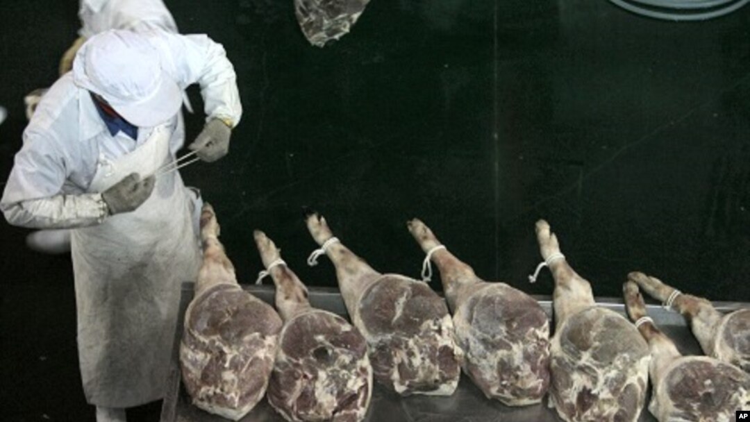 An employee at a workshop of a ham-processing factory in Jinhua, Zhejiang province April 10, 2011.