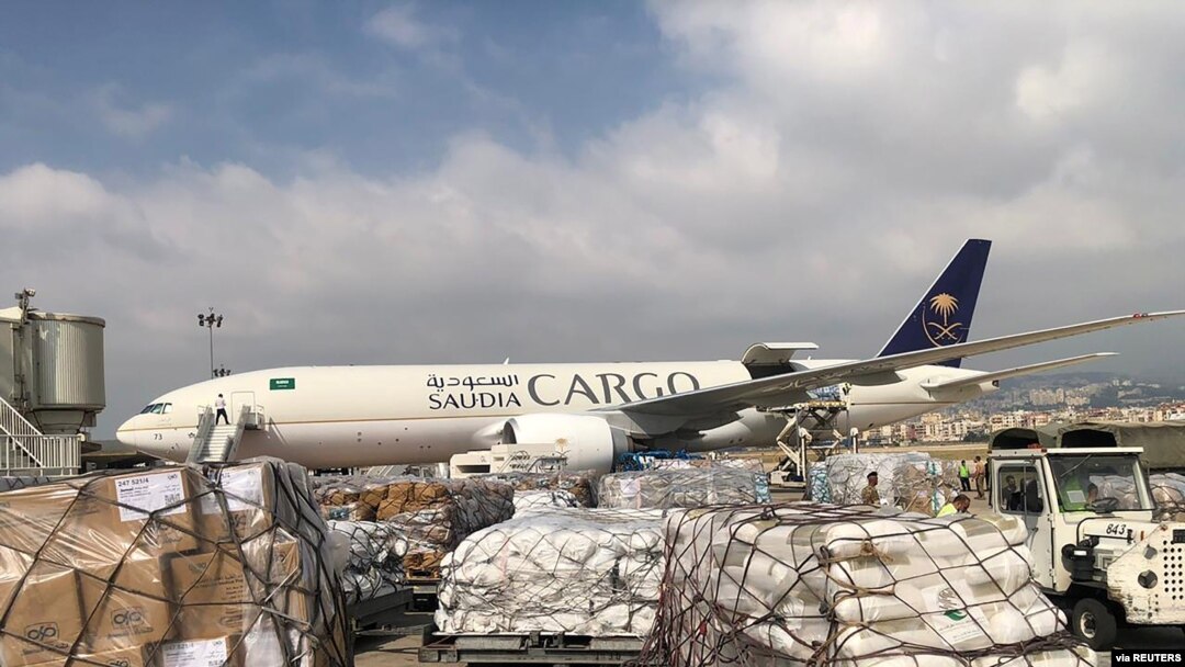 FILE - Staff members of King Salman Humanitarian Aid and Relief Center unload humanitarian aid at Beirut International Airport following a blast in Lebanon, Aug. 7, 2020. Analysts say Lebanon can no longer count on aid from wealthy Gulf Arab states.