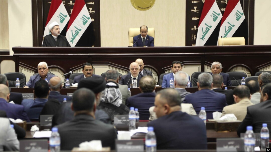FILE - Iraqi Prime Minister Haider al-Abadi, center, attends a session of the Iraqi Parliament, in Baghdad, Iraq, Sept. 27, 2017. Iraq's Kurdish lawmakers are reportedly ending to their boycott of the national parliament.