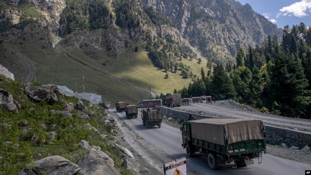 FILE - An Indian army convoy moves along the Srinagar-Ladakh highway at Gagangeer, northeast of Srinagar, Indian-administered Kashmir, Sept. 9, 2020. Control over the Ladakh border region is a key friction point between India and China.