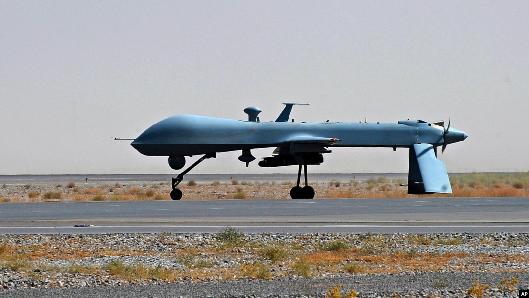 FILE - An unmanned U.S. Predator drone armed with a missile is seen standing on the tarmac.