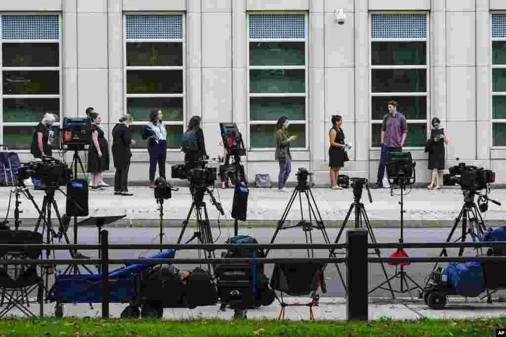 Television crew equipment is set up across the street as reporters and spectators line up outside Brooklyn Federal court for opening statements in R&B star R. Kelly's long-anticipated federal trial in New York, arising from years of allegations that he sexually abused women and girls.