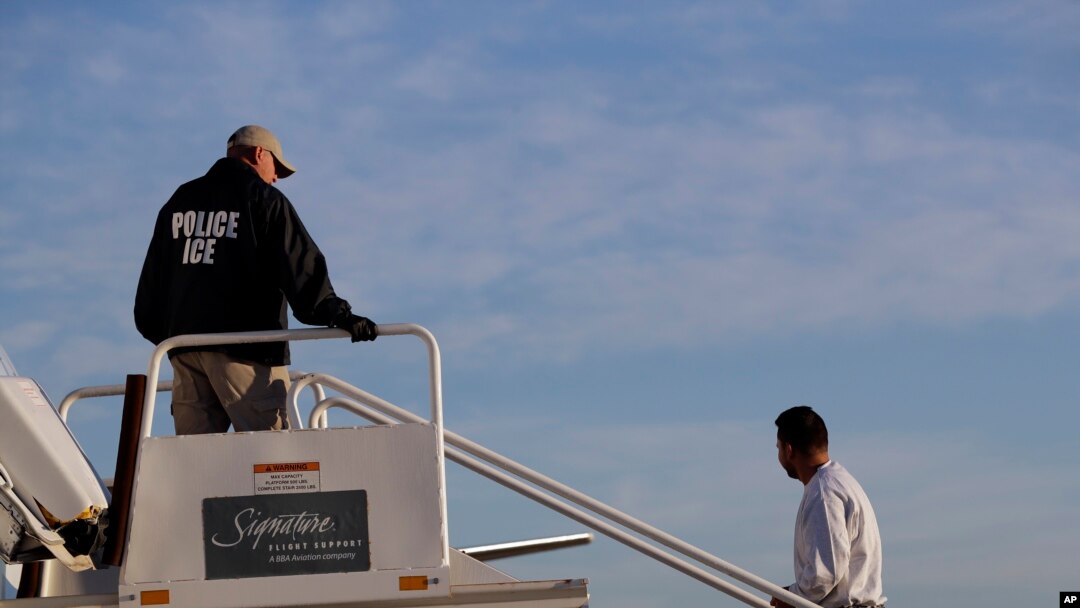 FILE - A to-be-deported illegal immigrant from Latin America boards a flight chartered by U.S. Immigration and Customs Enforcement, in Houston, Texas, Nov. 16, 2018. 
