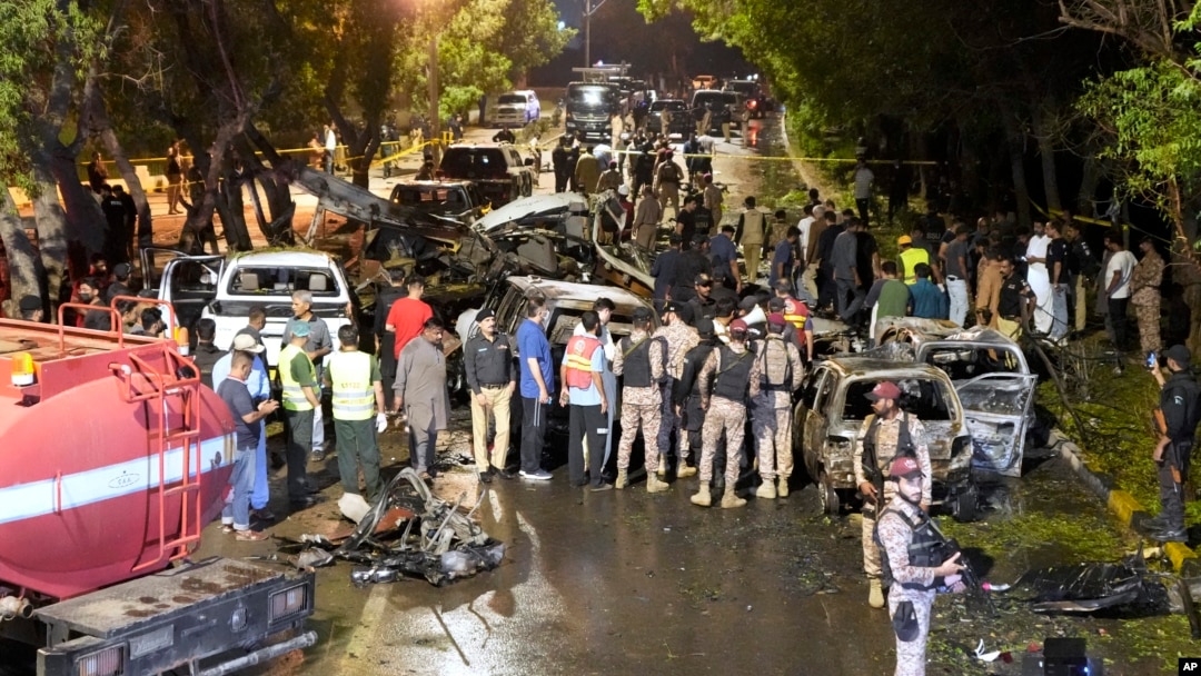 Security officers examine the site of an explosion outside Karachi airport, in Karachi, Pakistan, Oct. 7, 2024. 