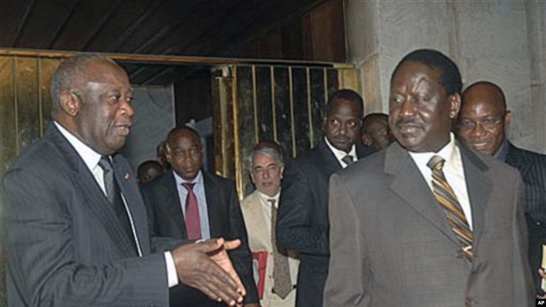 Ivory Coast strongman Laurent Gbagbo, left, talks with Kenyan Prime Minister Raila Odinga, an African Union envoy sent to mediate the ongoing Ivorian political standoff, following a meeting at the presidential palace in Abidjan, Ivory Coast, Jan 17, 2011