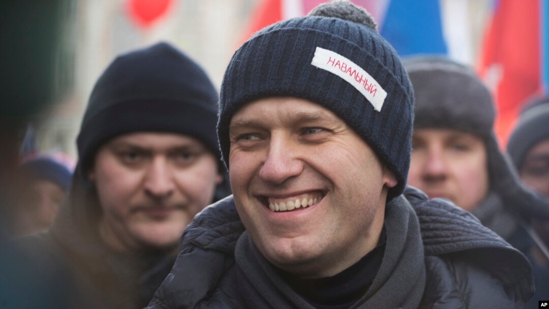 FILE - Russian opposition leader Alexei Navalny attends a rally in memory of opposition leader Boris Nemtsov, in Moscow, Feb. 25, 2018. Thousands of Russians took to the streets of Moscow to mark three years since Nemtsov was gunned down outside the Kremlin.
