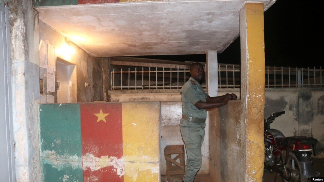 FILE - A security forces member stands guard at prison in Yaounde, Cameroon, Sept. 1, 2017.