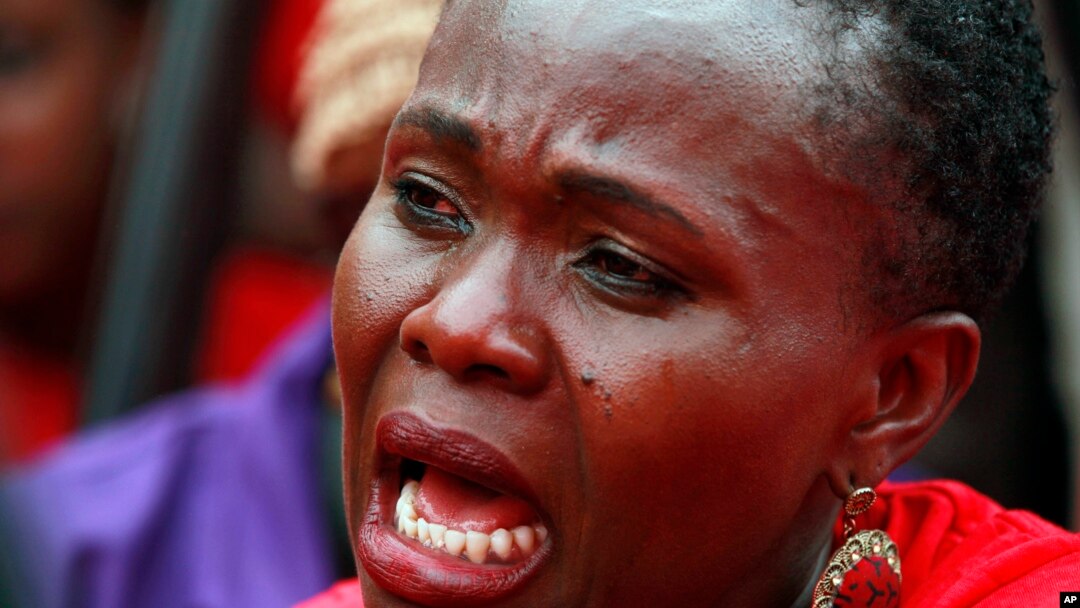 A woman attends a demonstration calling on the government to rescue the kidnapped Chibok school girls, outside the defense headquarters in Abuja, Nigeria, May 6, 2014. 