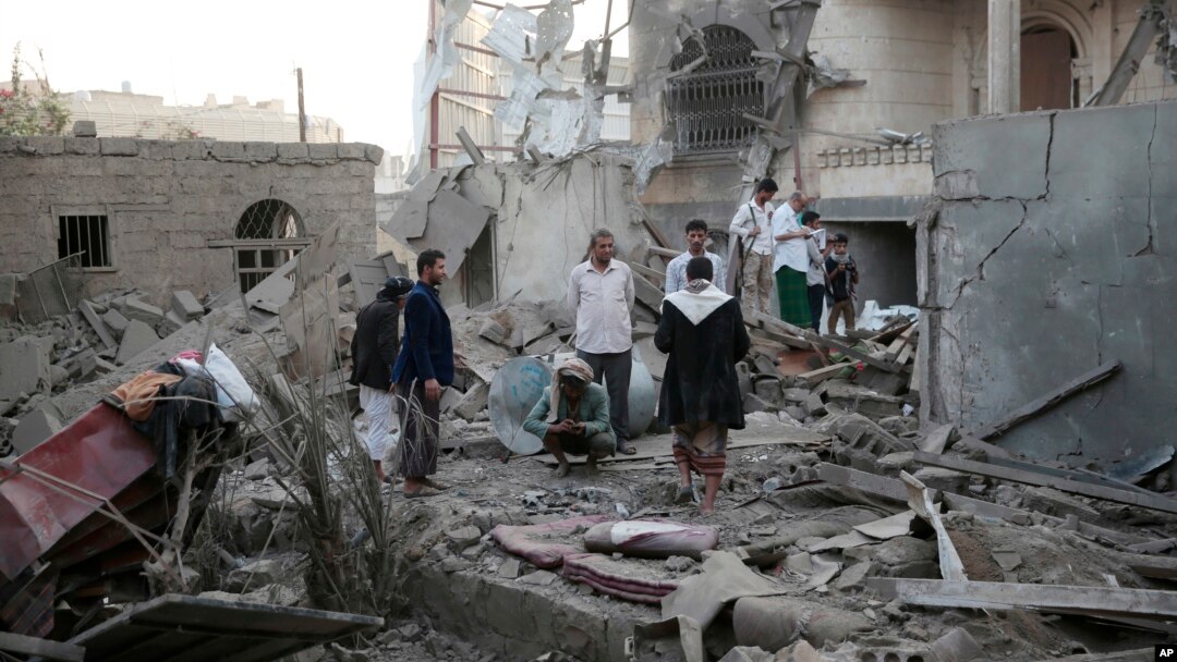 FILE - People inspect the damage of houses destroyed by Saudi-led airstrikes in Sanaa, Yemen, Jun. 9, 2017. 
