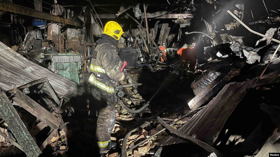 Firefighters work at a site of a warehouse heavily damaged during a Russian drone strike, amid Russia's attack on Ukraine, in Kyiv region, Ukraine, released Dec. 21, 2023. (Press service of the State Emergency Service of Ukraine in Kyiv region/Handout via REUTERS)