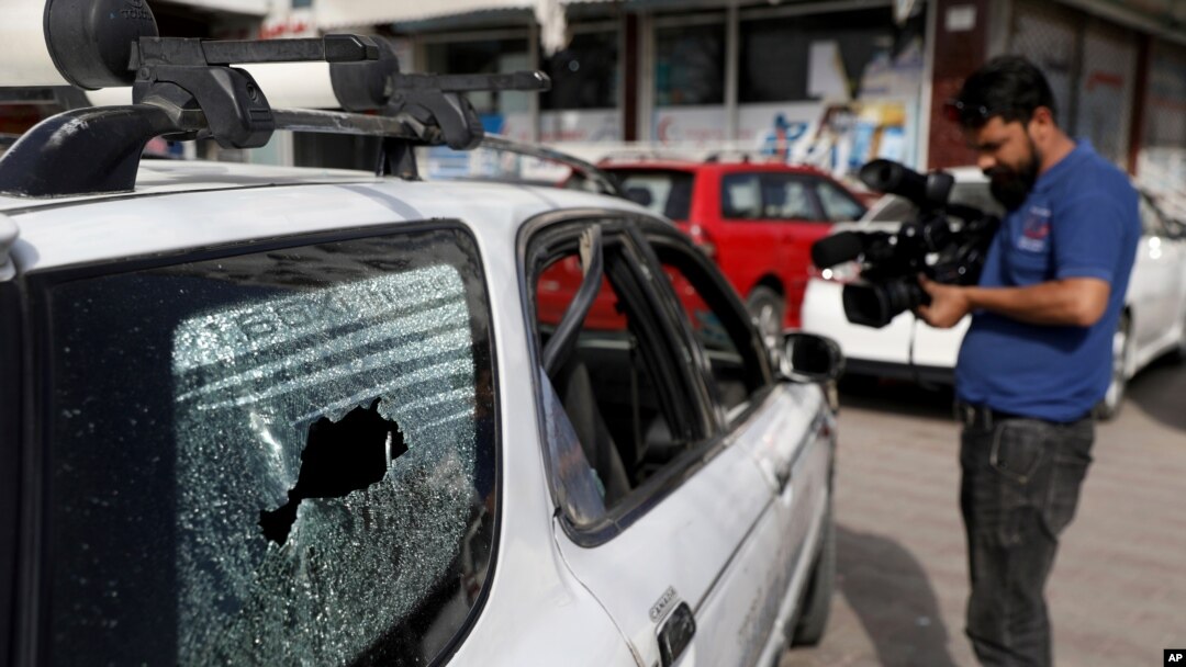 Afghan journalists films the vehicle in which director of Afghanistan's Government Information Media Center Dawa Khan Menapal was shot dead in Kabul, Afghanistan, Aug. 6, 2021.