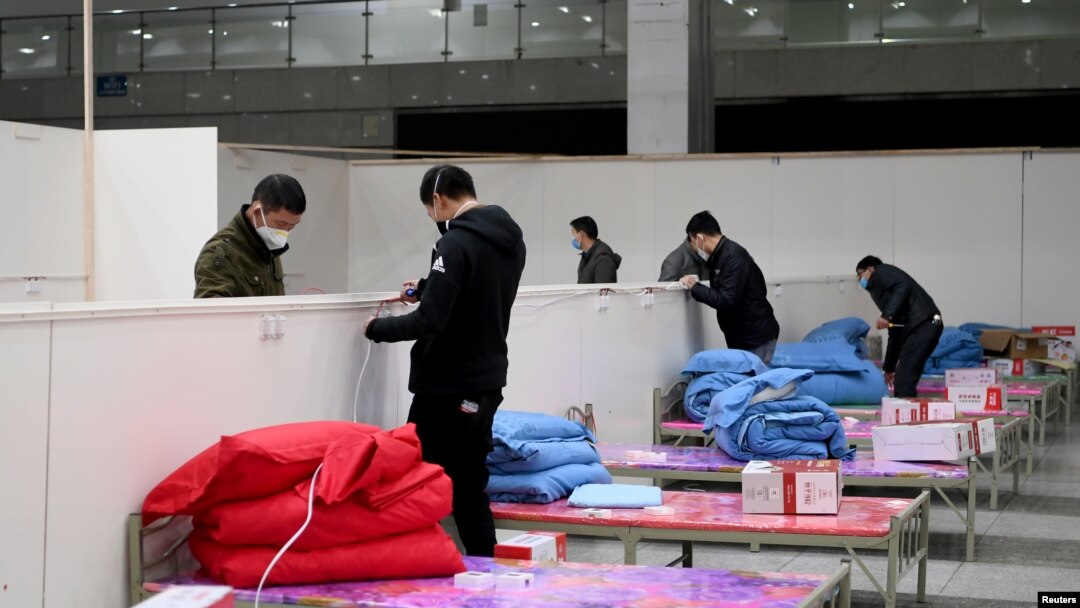 Workers set up infrastructure at the Wuhan International Conference and Exhibition Center to convert it into a makeshift hospital to receive patients infected with the new coronavirus, in Wuhan, Hubei province, China, Feb. 4, 2020. 